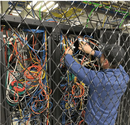 Disorganized server rack back view before BomberJacket service